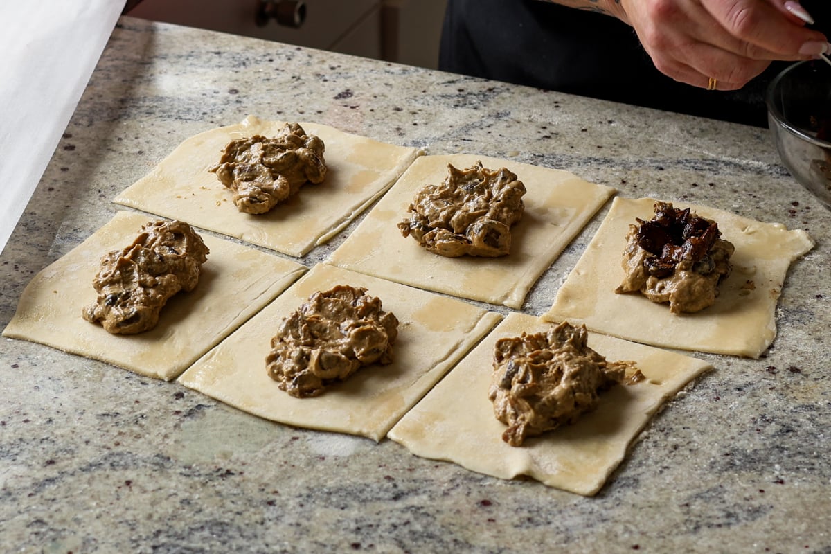 adding creamy mushrooms and sautéed mushrooms to the puff pastry