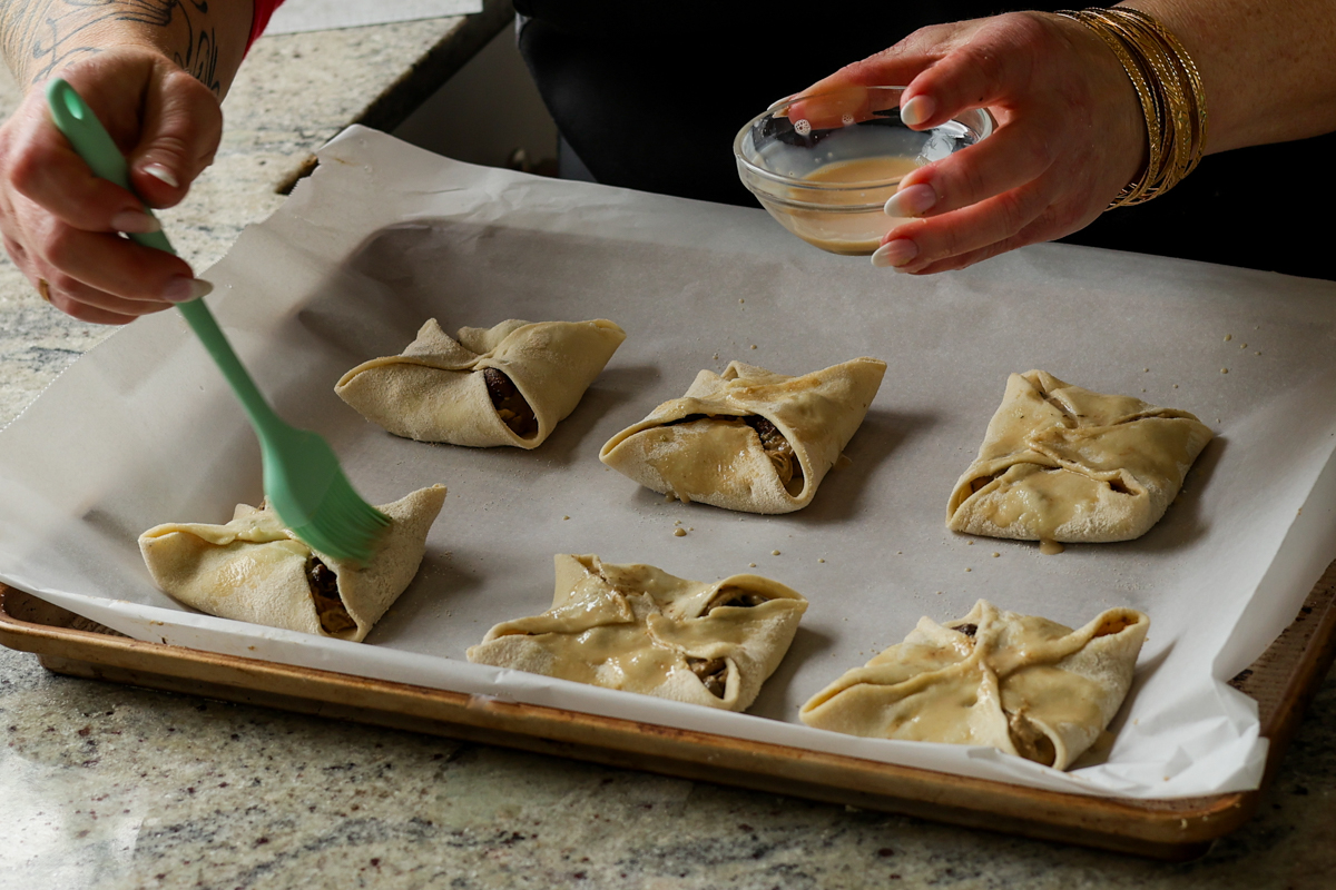 brushing pastry wash onto the puff pastry