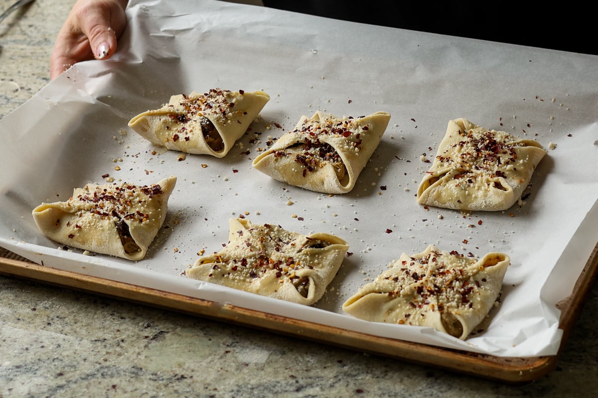 mushrooms puffs on the baking sheet before baking
