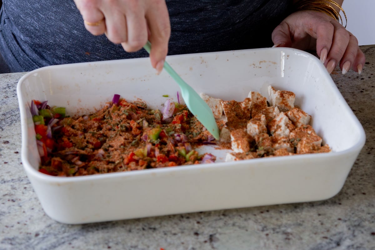 stirring spices into the tofu