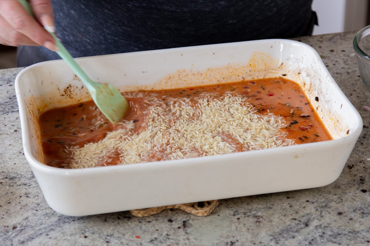 adding rice to the baking pan