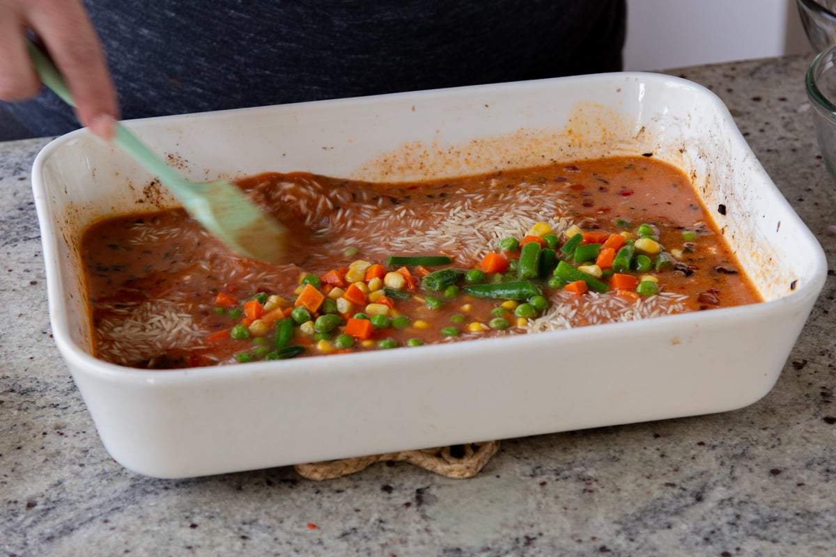 adding veggies to the baking pan
