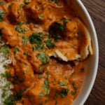 plate of vegan butter chicken with naan