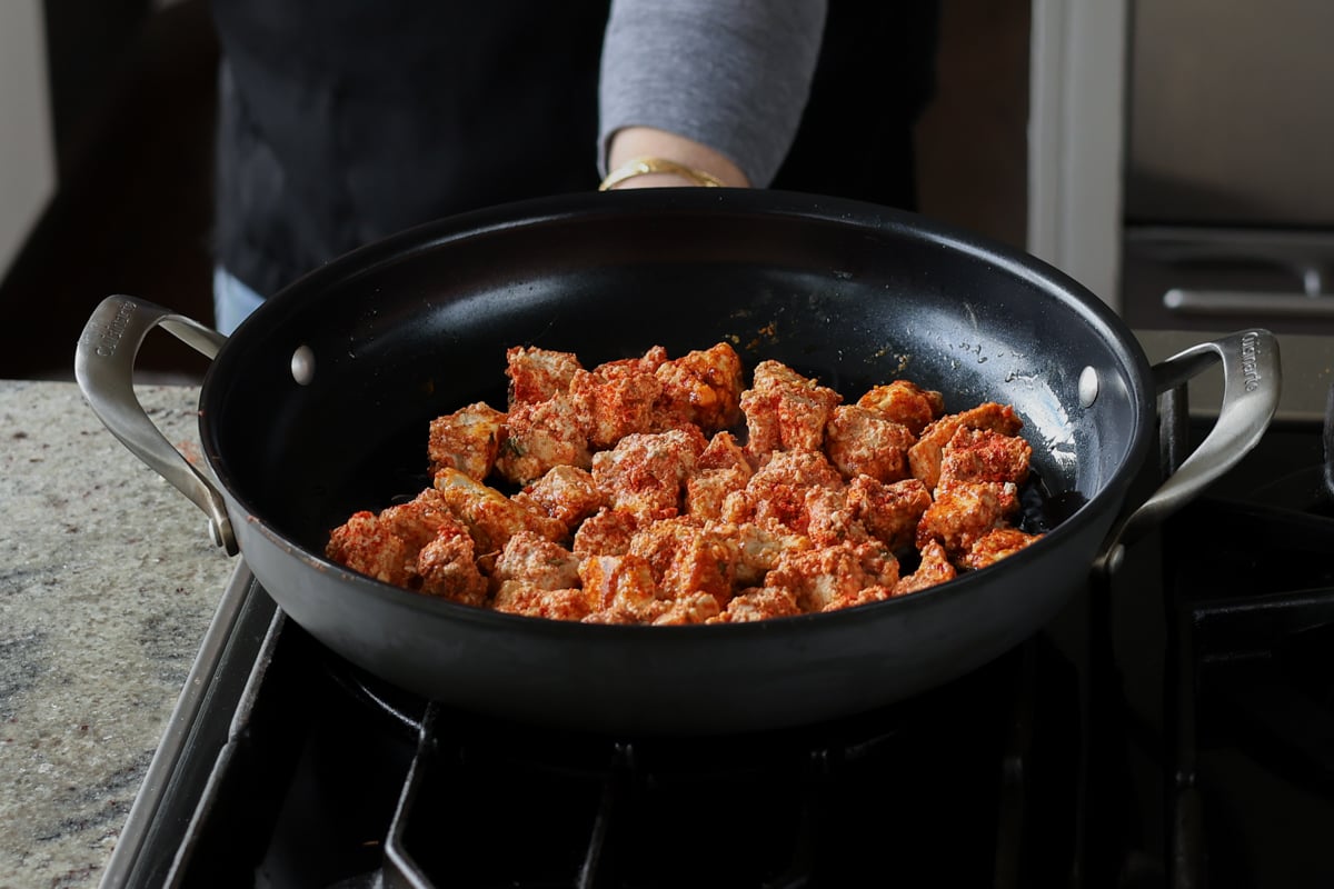 adding tofu to the pan