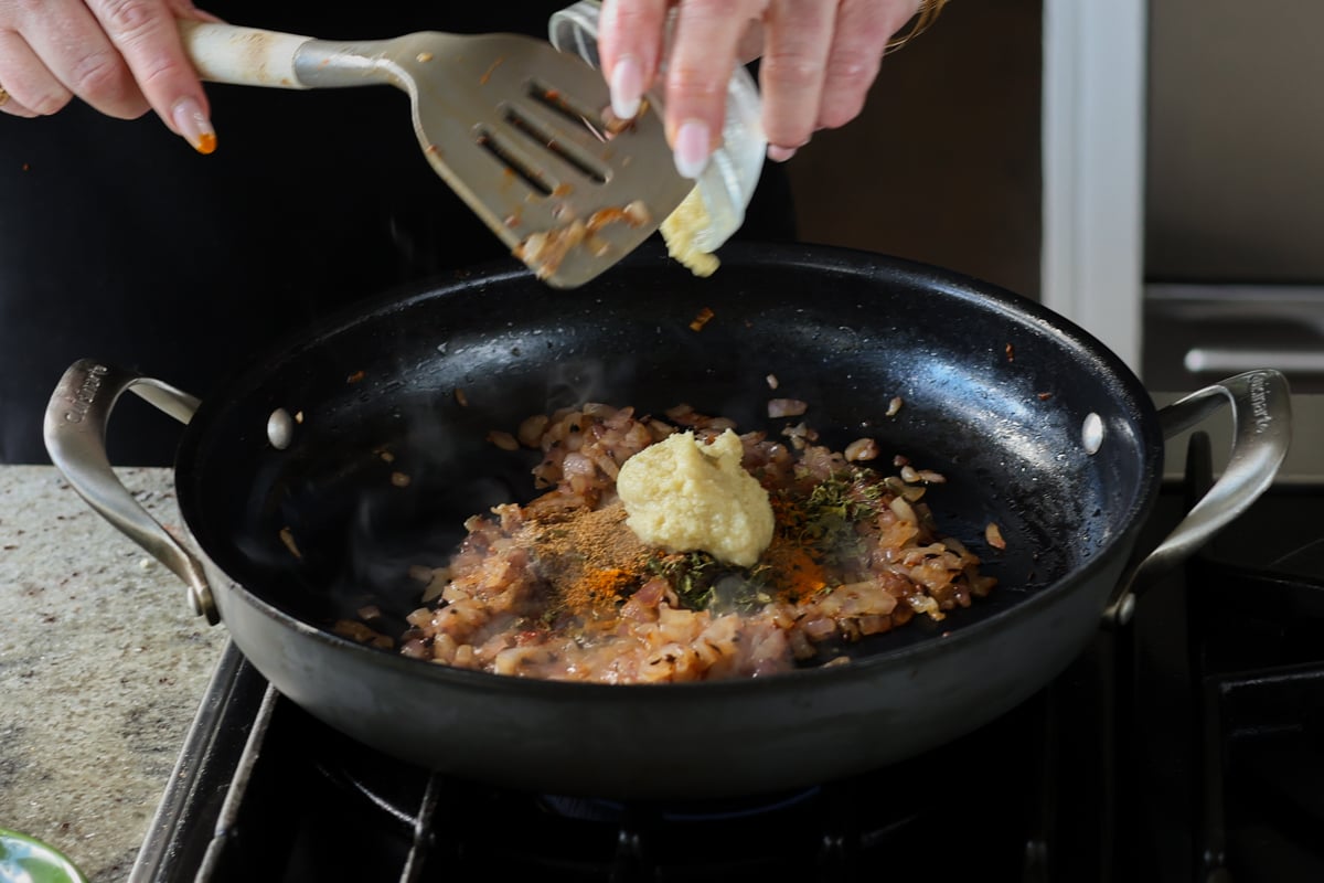 adding ginger garlic paste to the pan