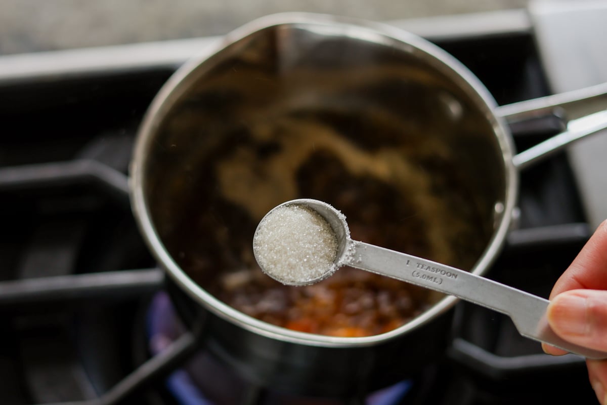 adding sugar to the pan