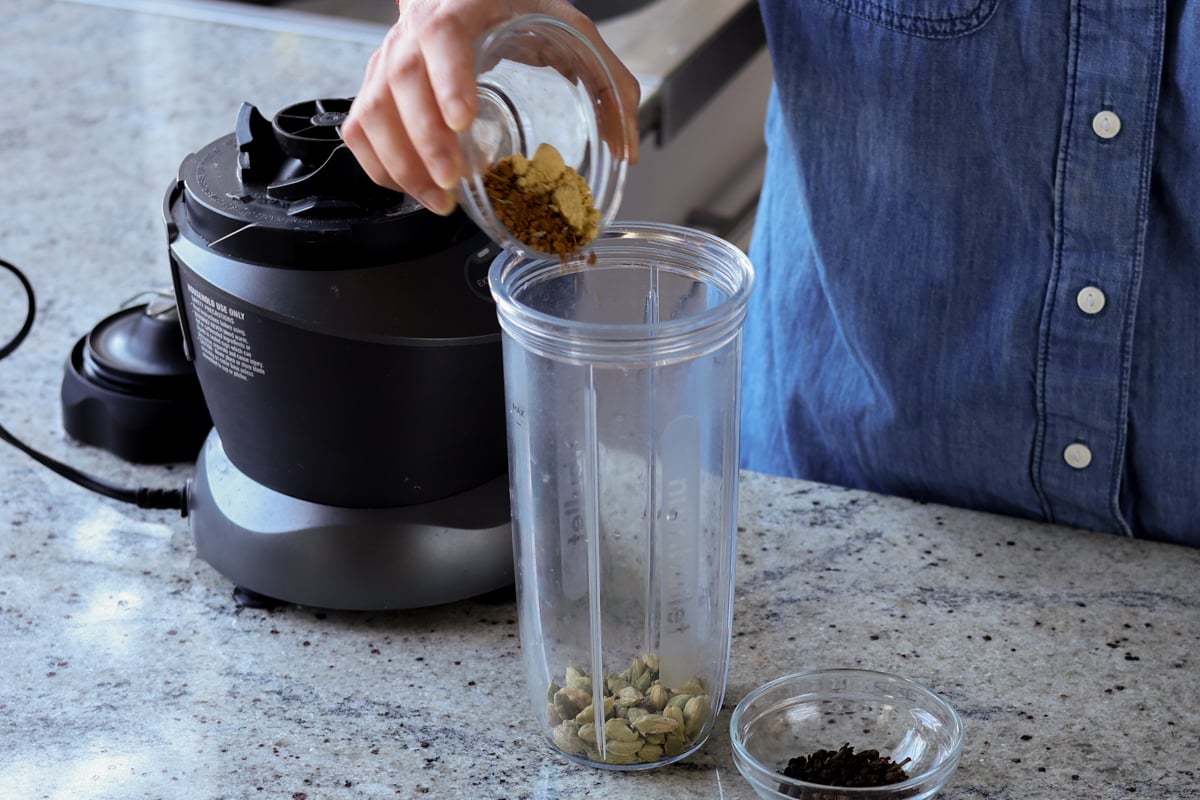 adding spices to the blender