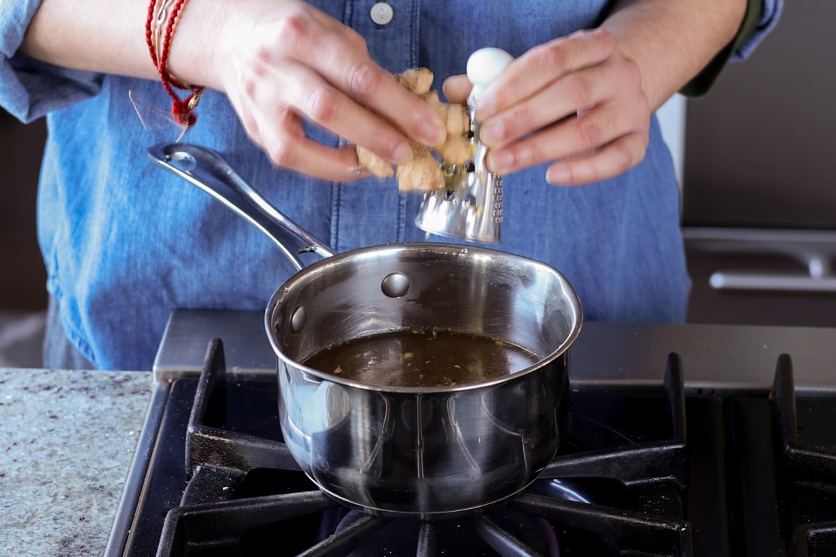 grating ginger into the pan
