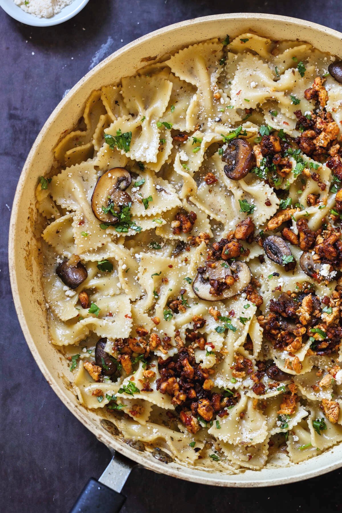 chili miso pasta in the pan topped with tofu crumbles
