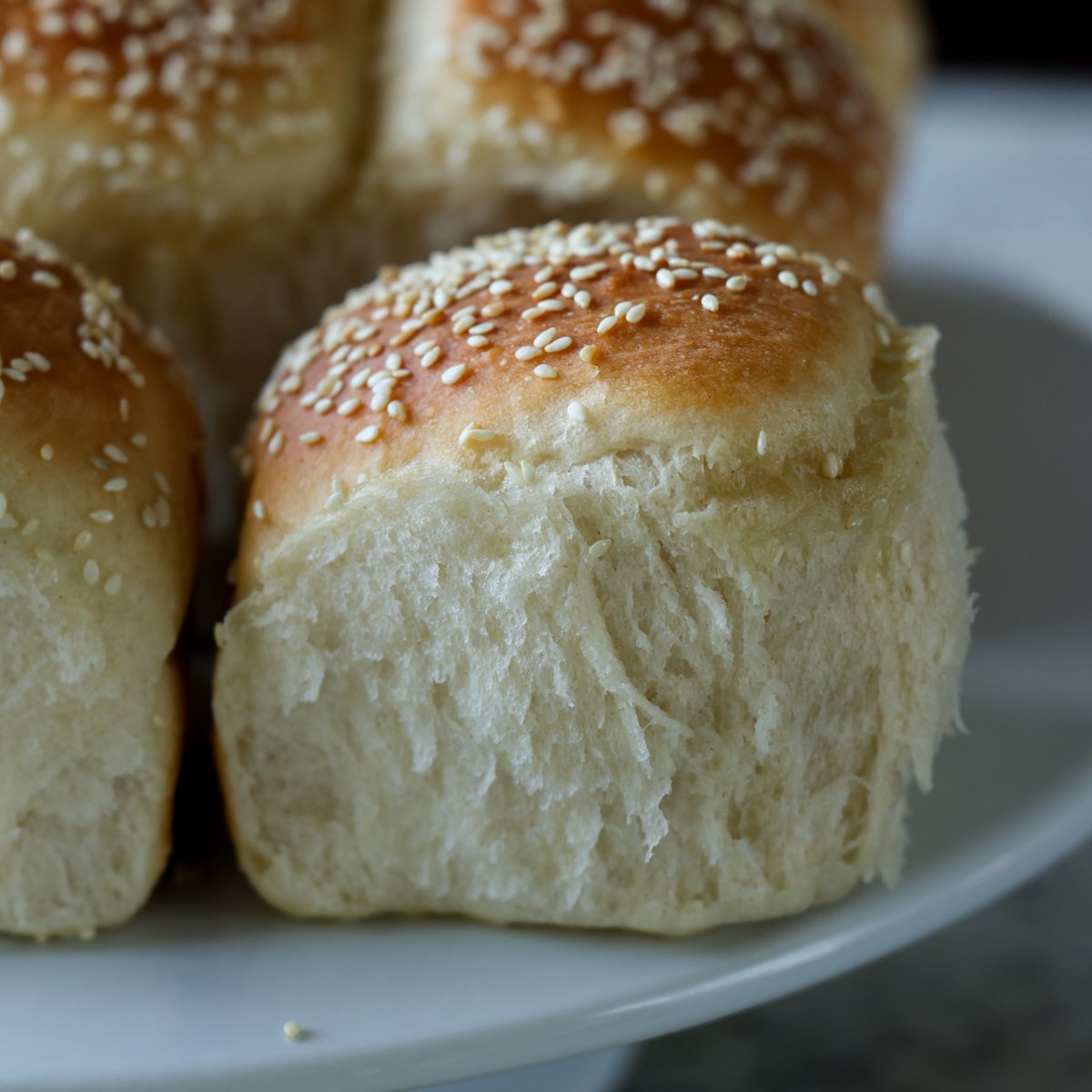 fluffy dinner rolls on a serving tray after pulling apart