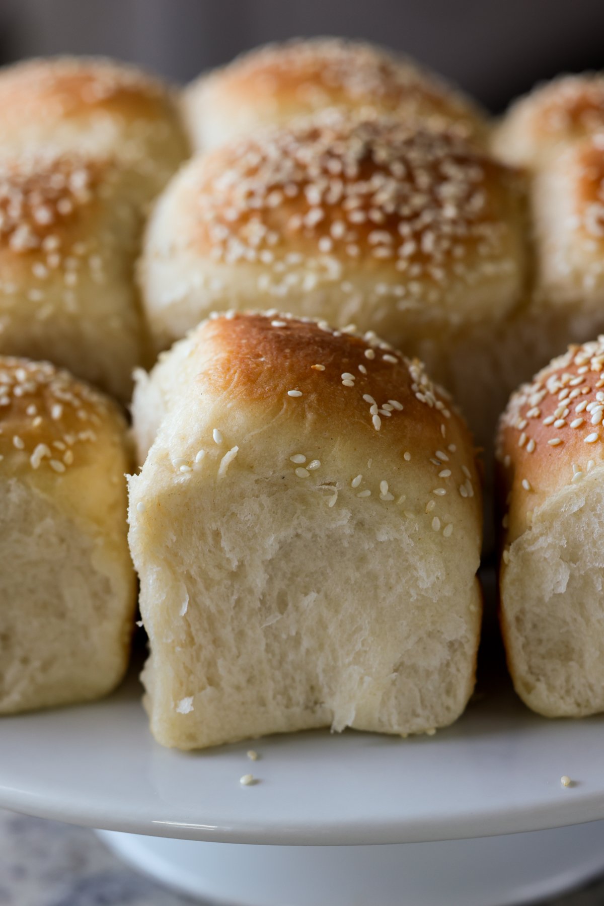 fluffy dinner rolls on a serving tray after pulling apart