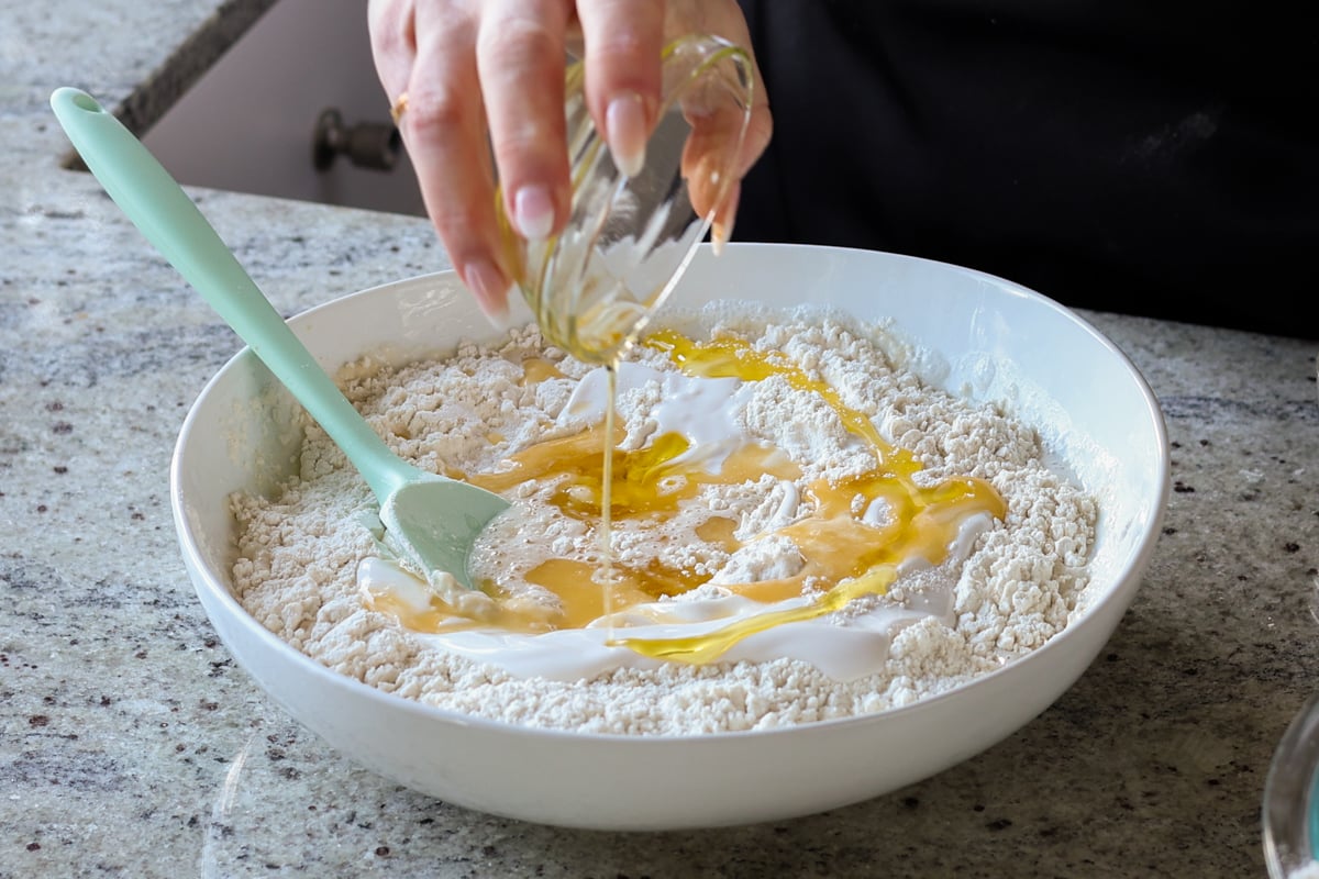 adding melted vegan butter and oil to the dough