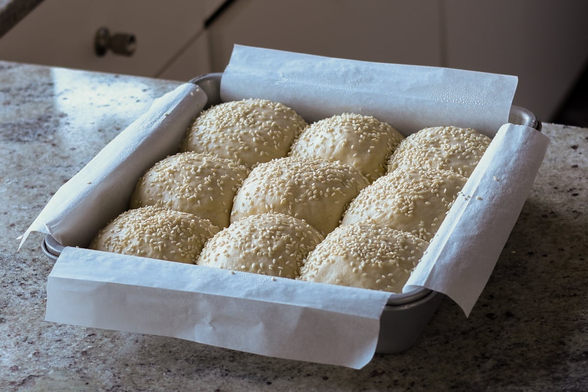 sprinkling seeds onto the dinner rolls before baking