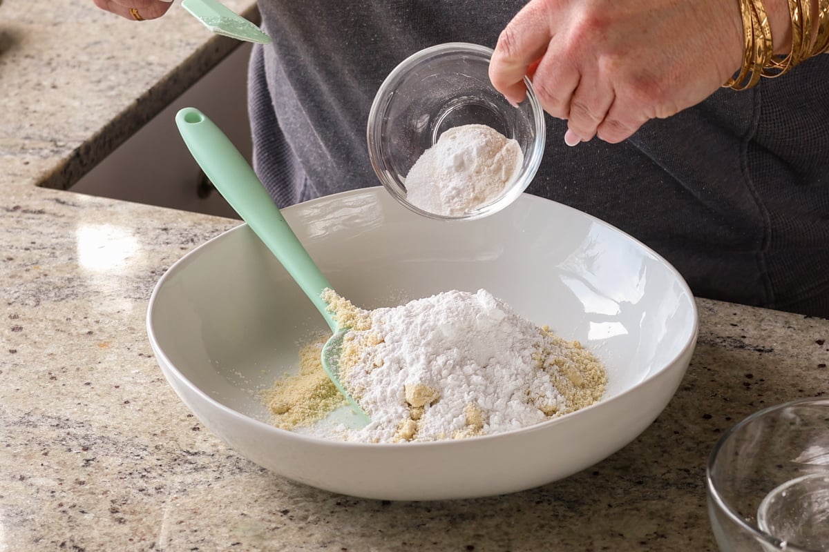adding dry ingredients to the bowl