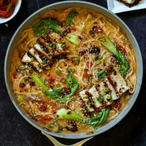 panful of creamy tahini ramen with teriyaki tofu on top
