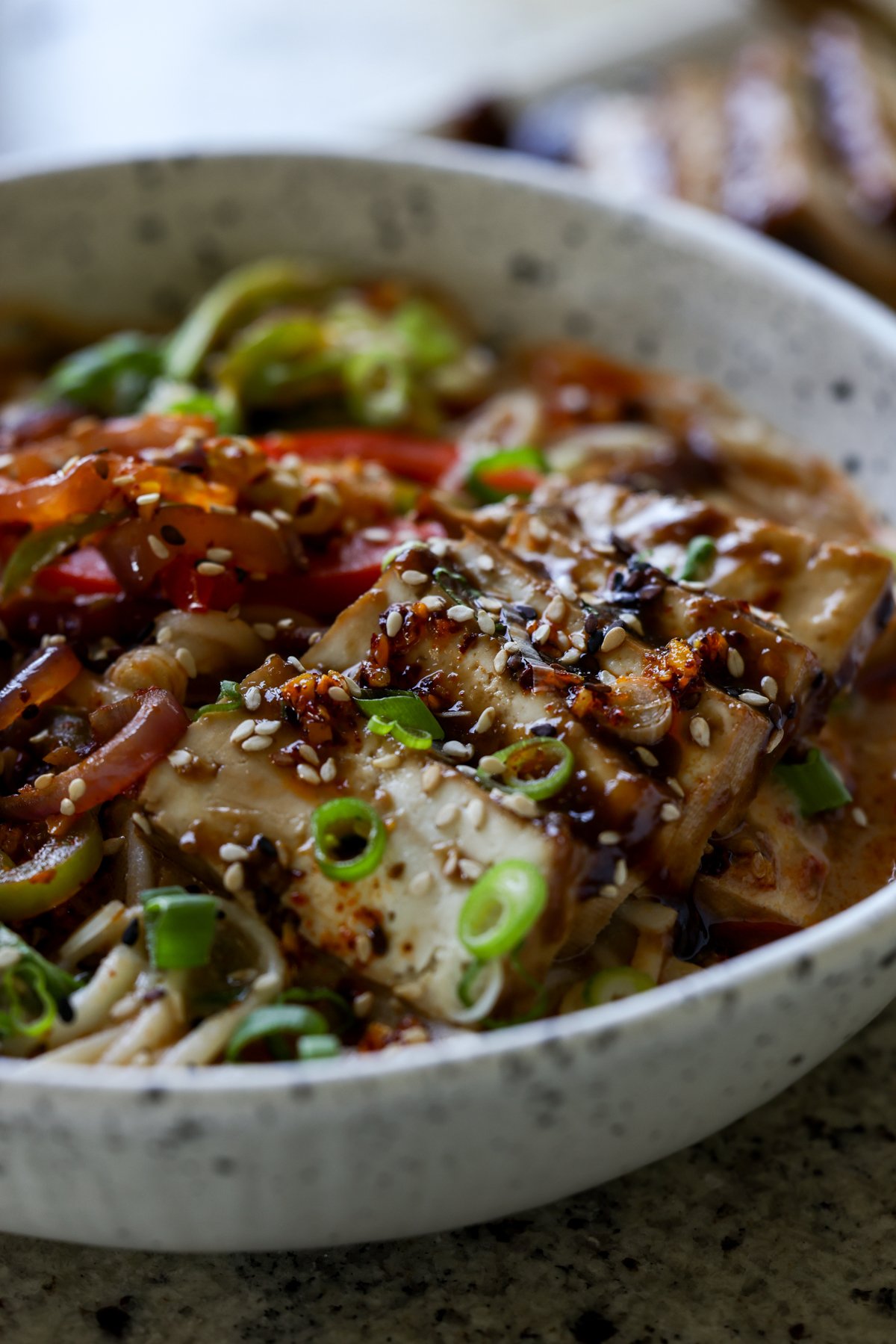 close-up of bowl of creamy tahini ramen with teriyaki tofu on top