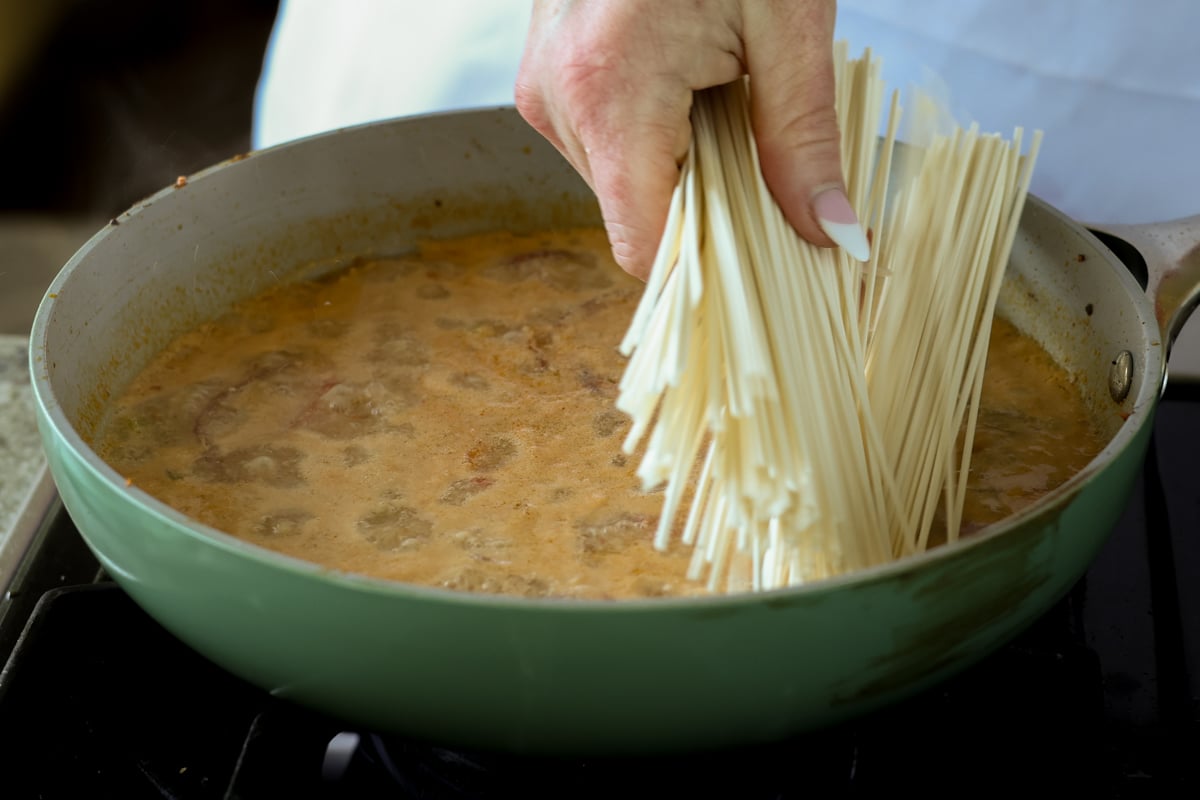 adding ramen noodles to the tahini broth