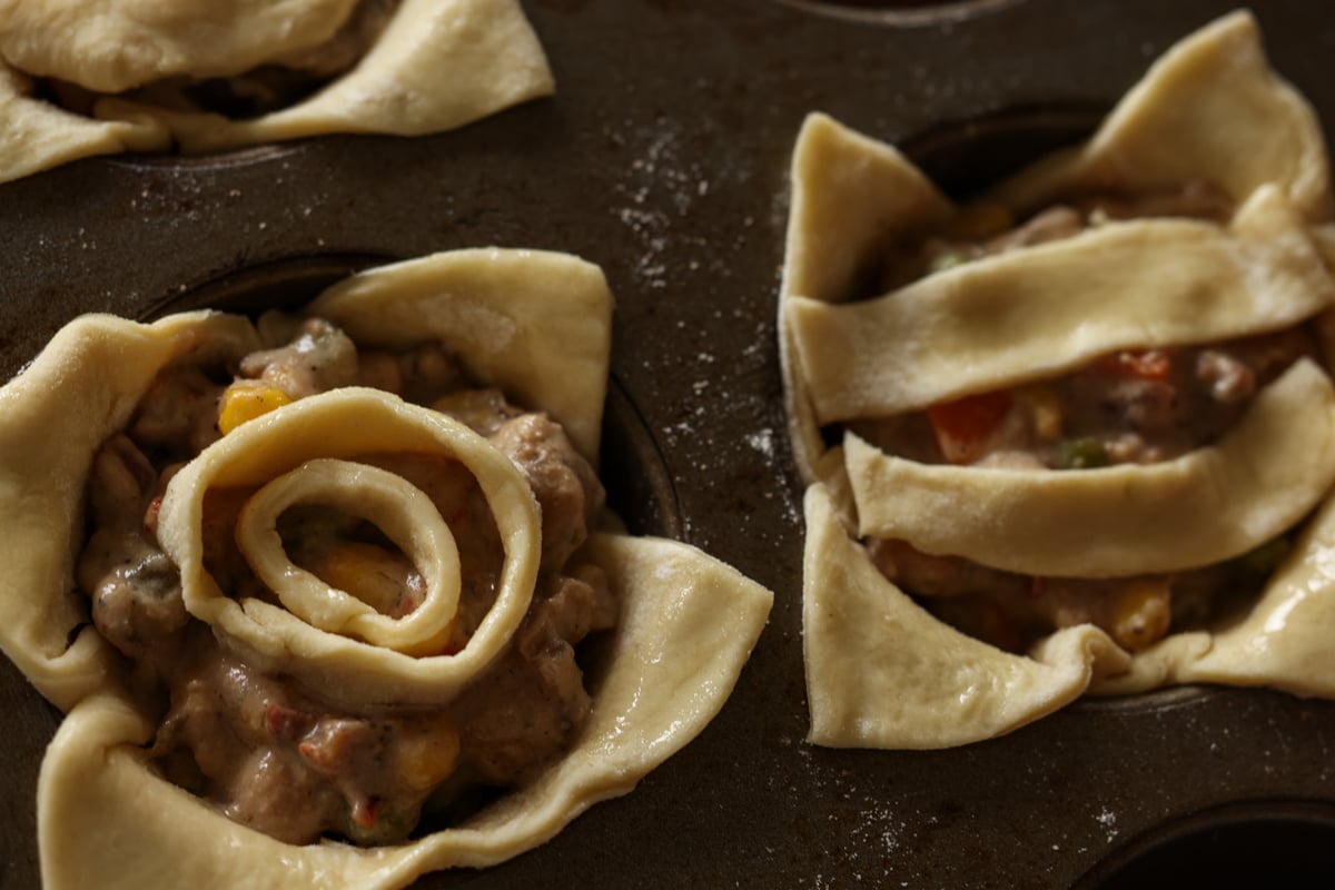 mini pot pies in the muffin tin before baking