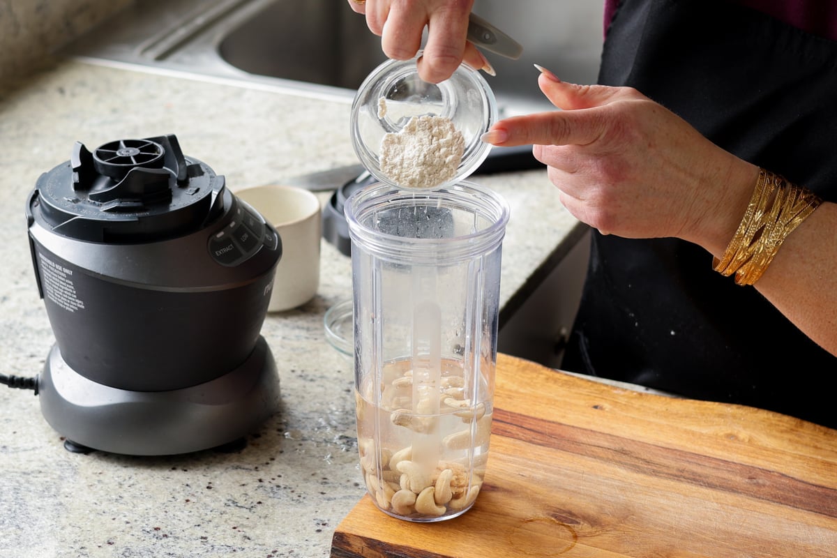 adding cashew cream ingredients to the blender