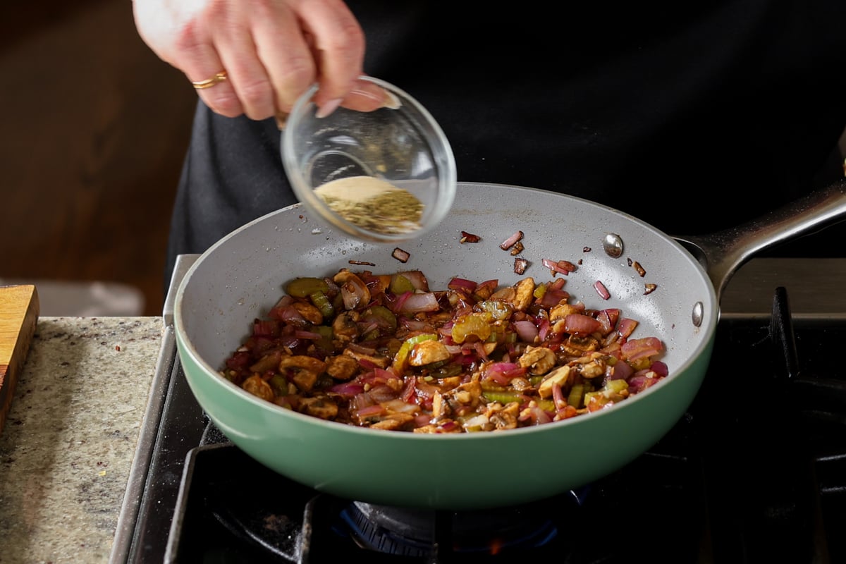 adding herbs and spices to the pan