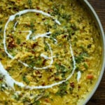 close-up of prepared khichdi in the pan with non-dairy yogurt swirl