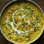 prepared khichdi in the pan with non-dairy yogurt swirl