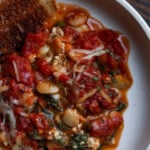 close-up of butterbean parmigiana on a plate with toasted sourdough