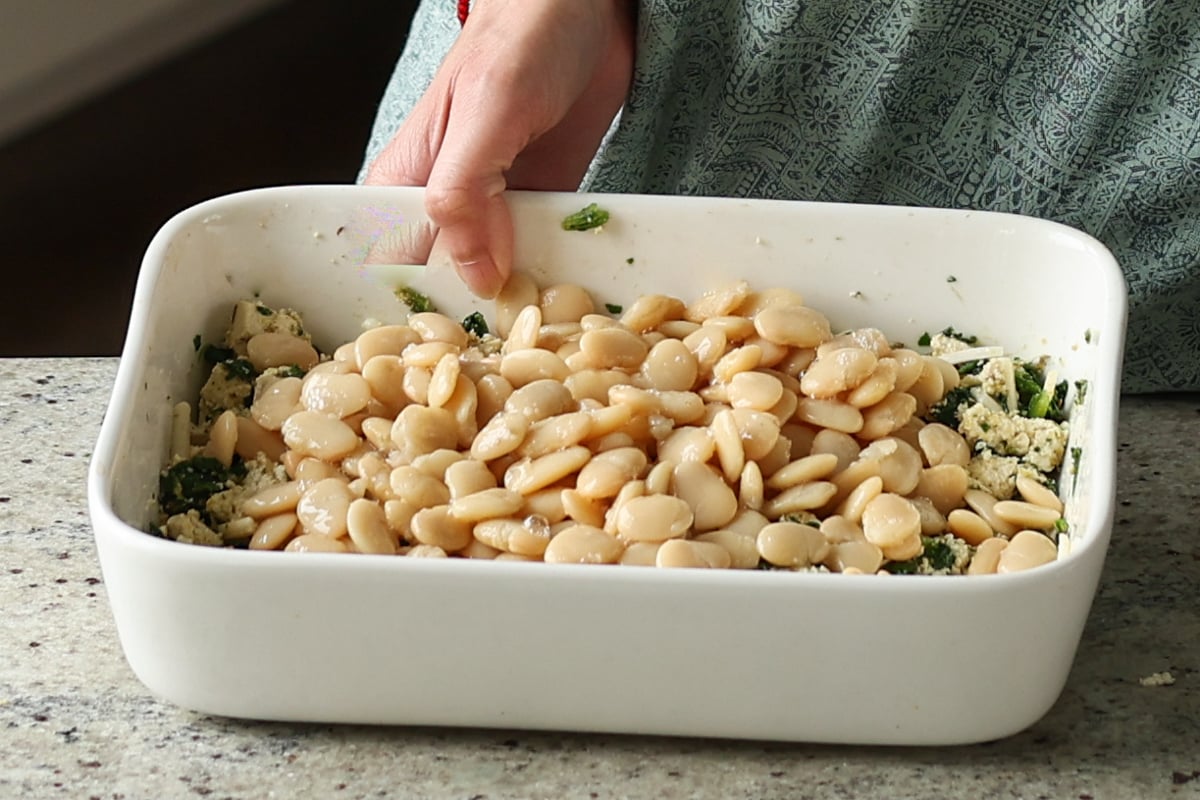 adding beans to the pan