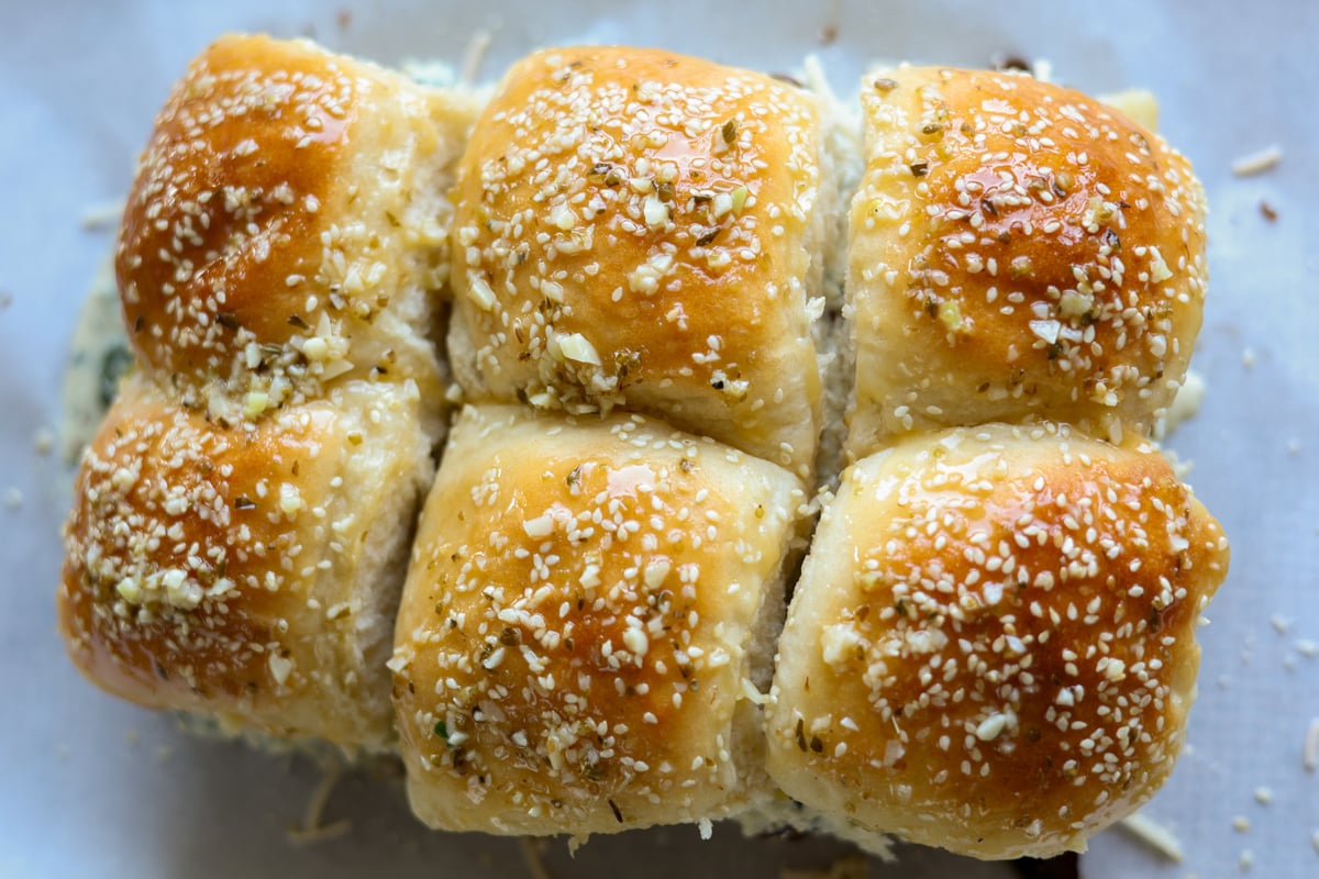 cheesy mushroom sliders on the baking sheet before baking