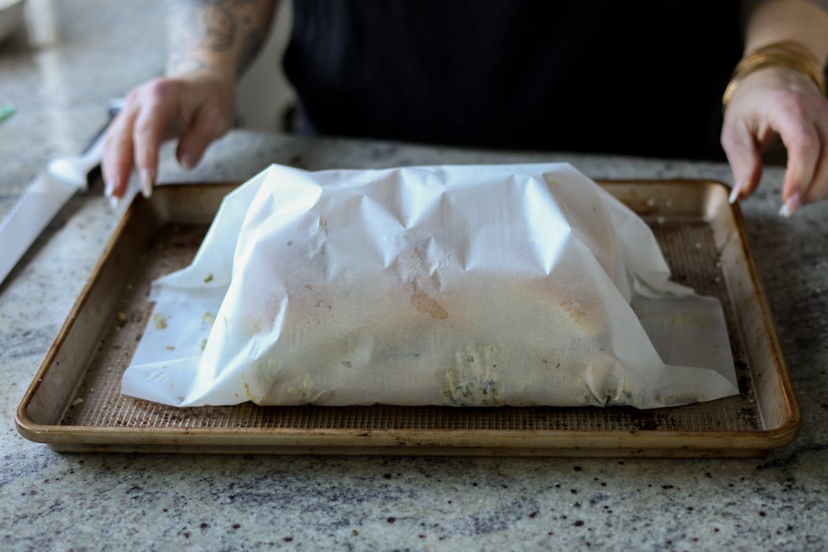cheesy mushroom sliders on the baking sheet wrapped in parchment