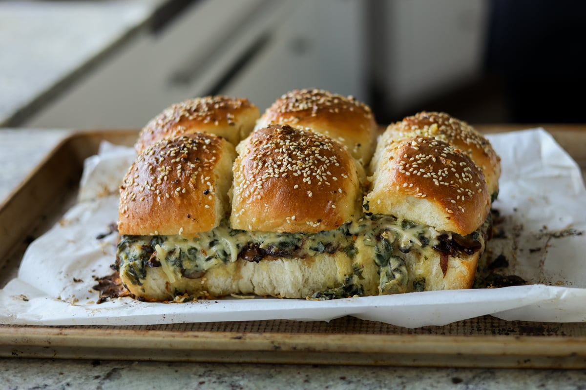 cheesy mushroom sliders on the baking sheet after baking