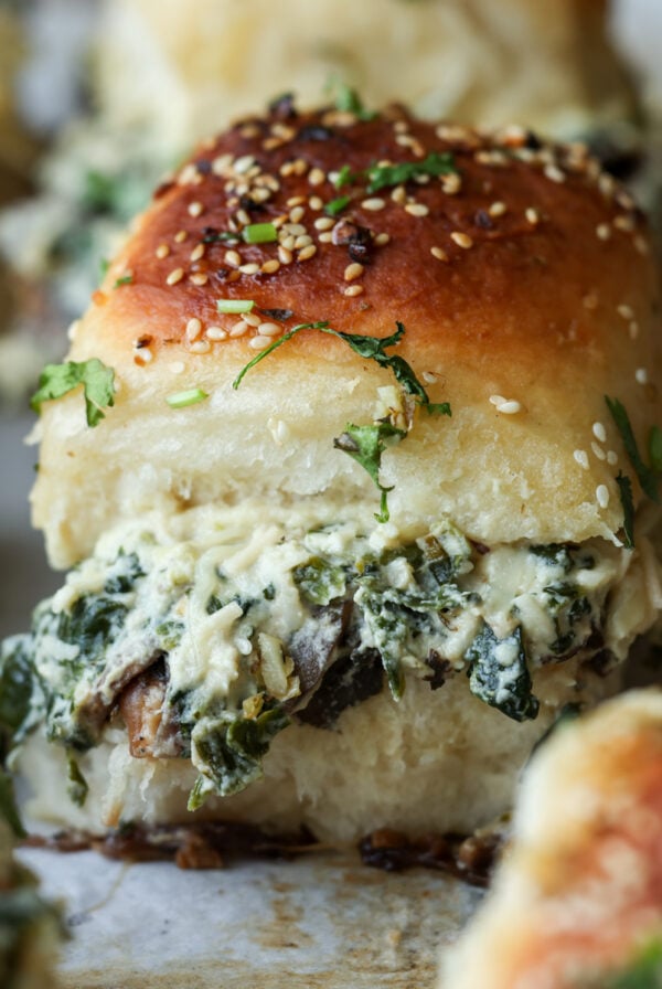 close-up of cheesy mushroom sliders on the baking sheet after baking
