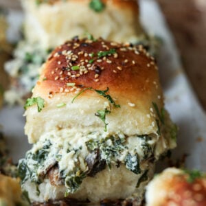 close-up of cheesy mushroom sliders on the baking sheet after baking