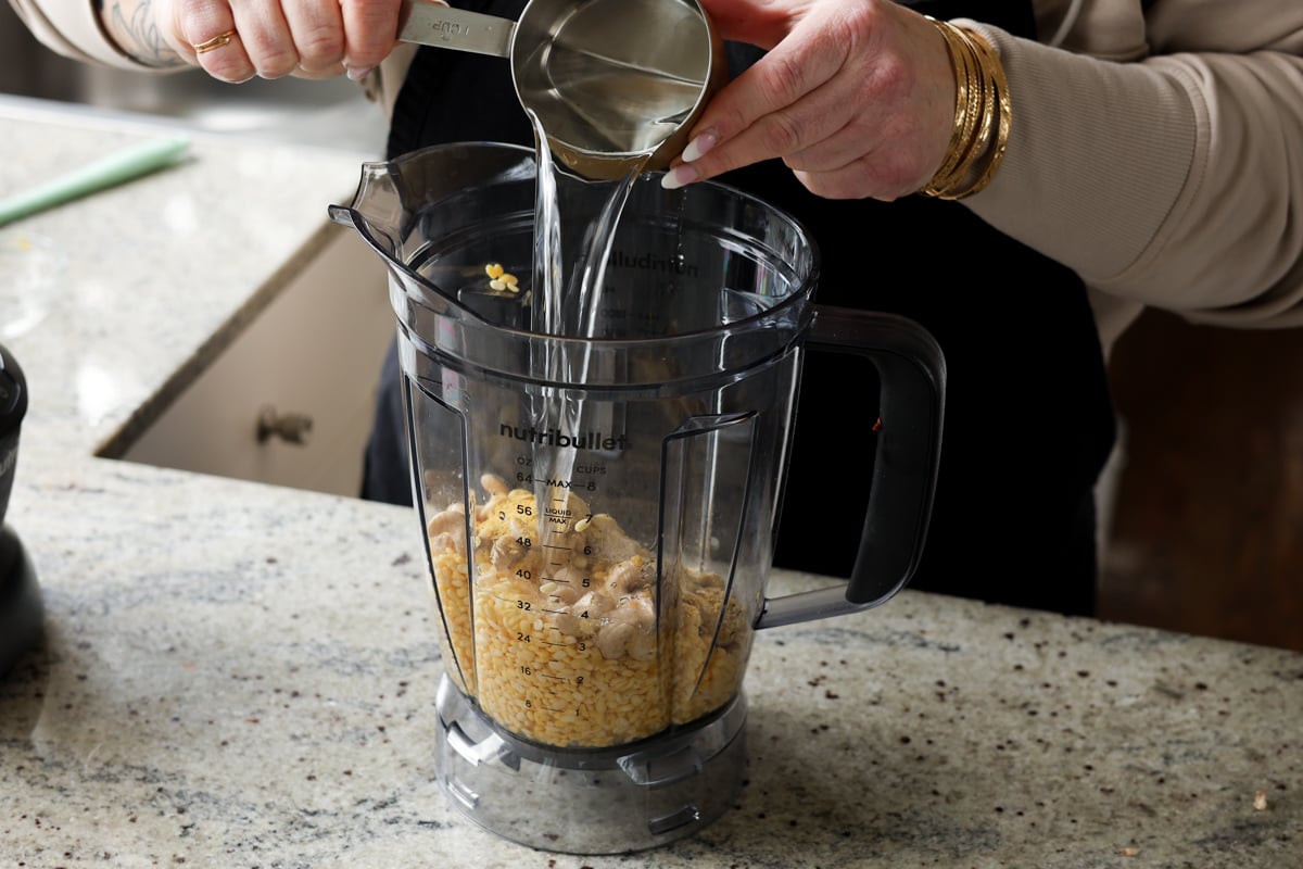 adding water to the blender