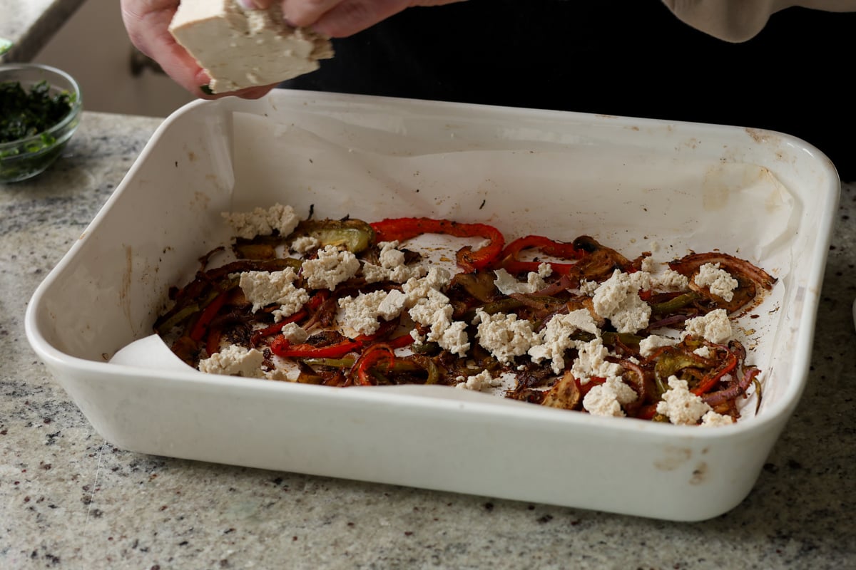crumbling tofu into the roasted veggies