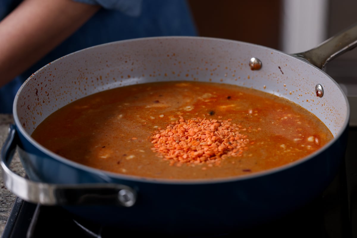 adding lentils to the pan