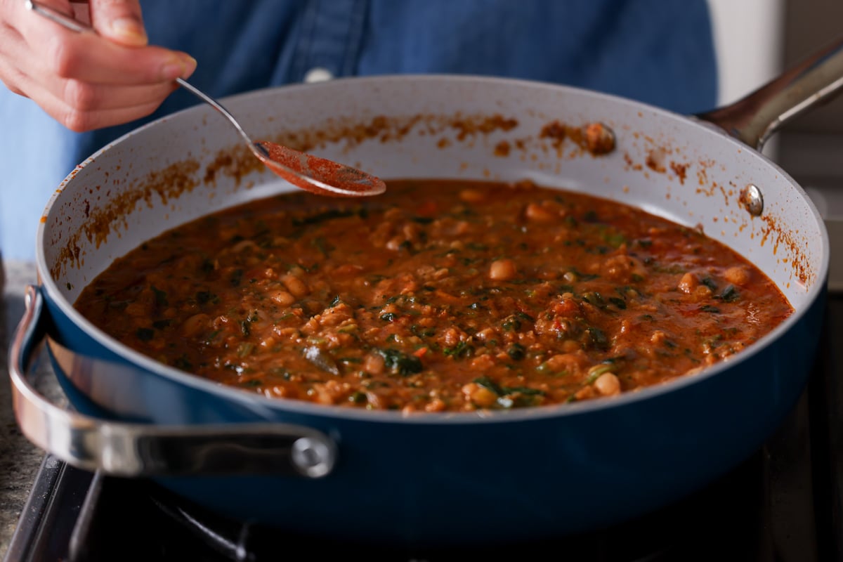 sprinkling extra spices onto the stew