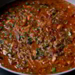 close-up of lentil bean stew in the pan after cooking and garnishing