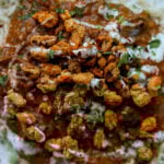 close-up of balchao mushrooms over rice topped with crispy beans