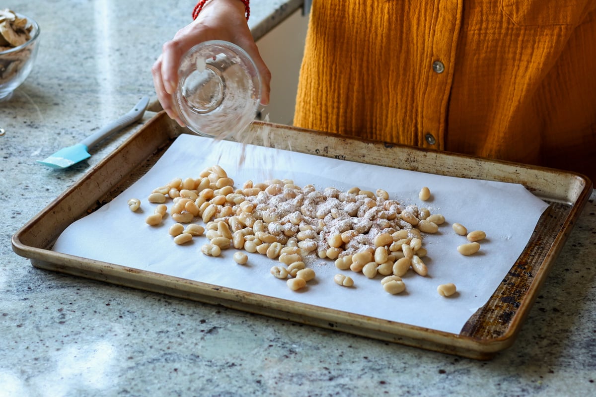 adding cornstarch and spices to the beans
