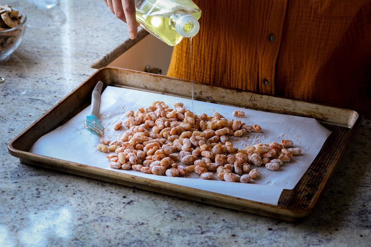 adding oil to the beans