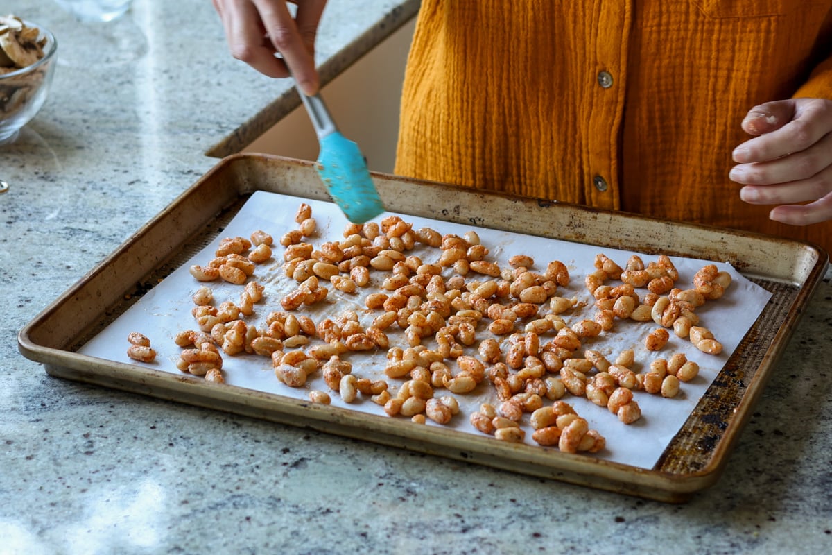 spreading the beans on the baking sheet