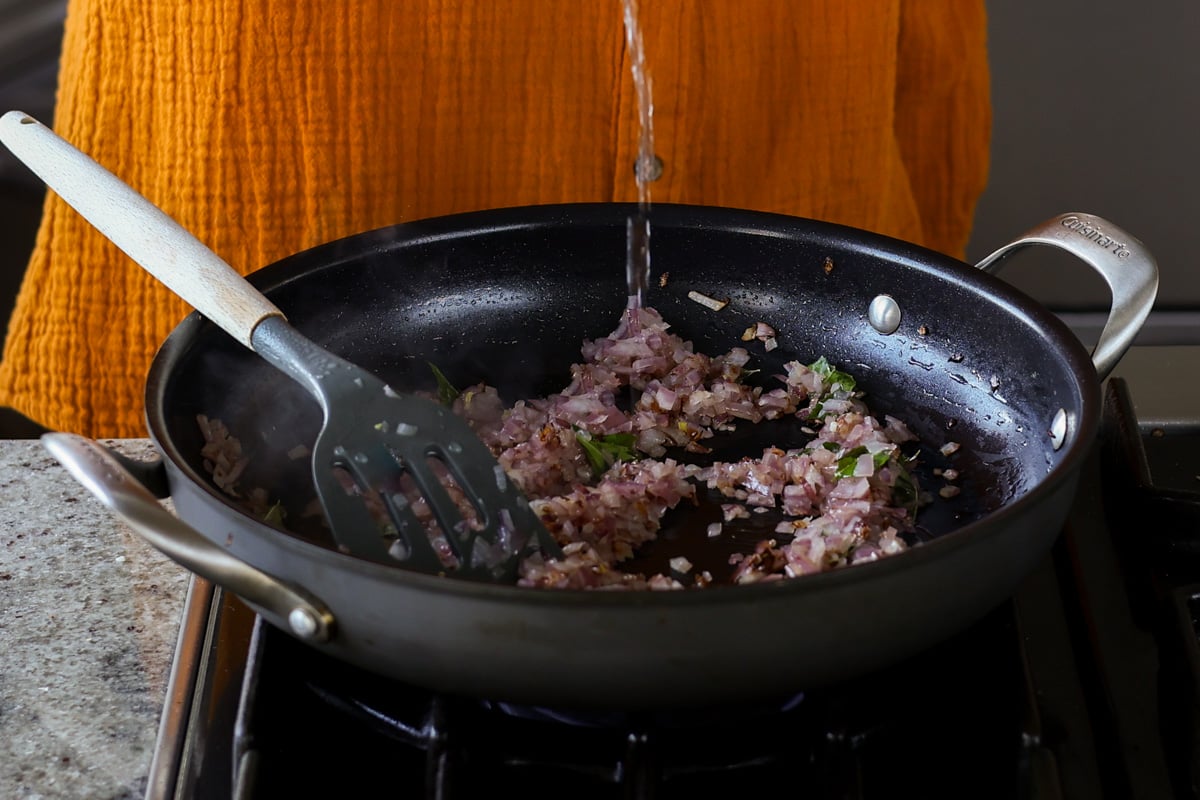 adding water to the pan