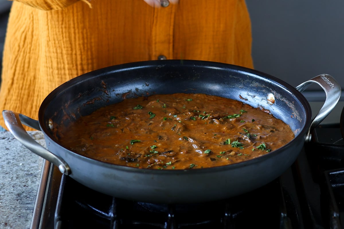 topping balchao mushrooms with cilantro