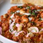 close-up of beans korma in a bowl with flatbread