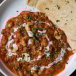 beans korma in a bowl with flatbread