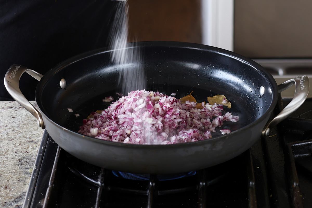 adding onion and salt in the pan