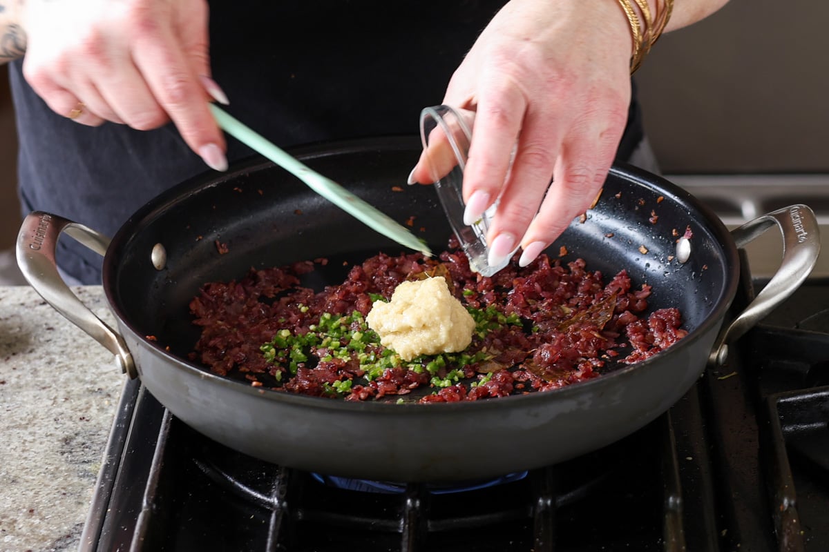 adding more aromatics to the pan