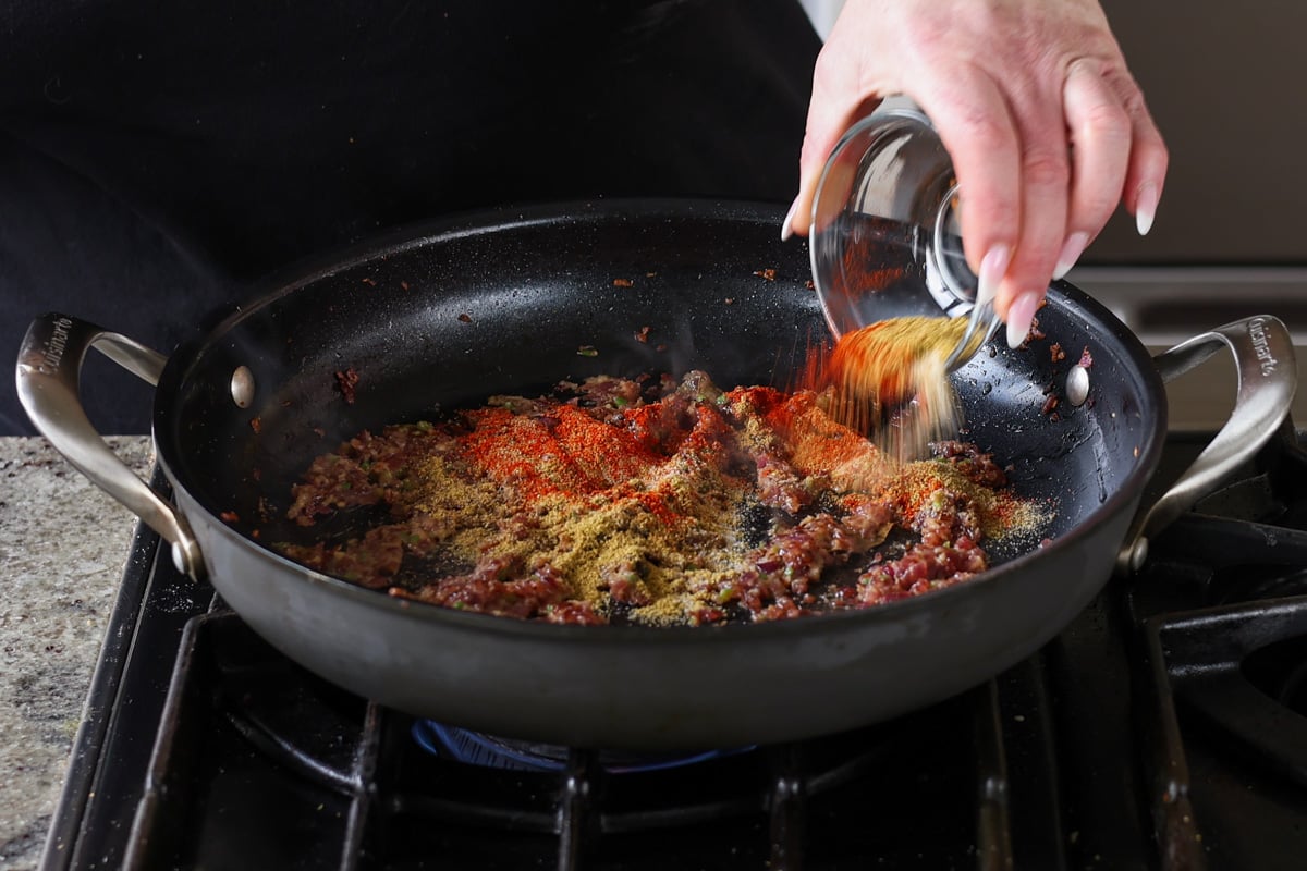 adding ground spices to the pan