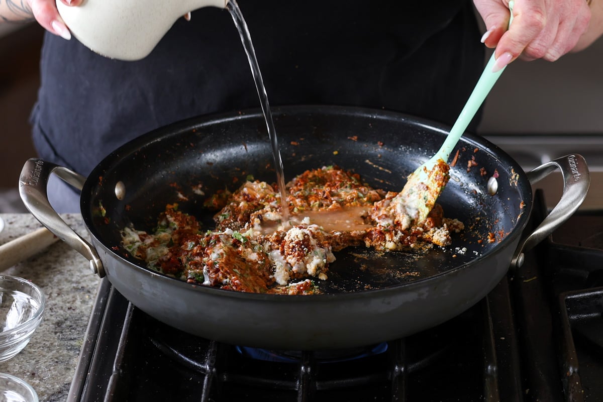 adding water to the sauce mixture